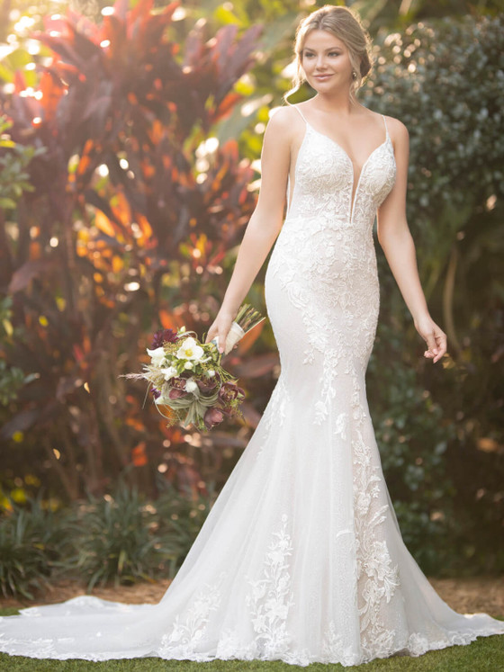 Floral lace appliqués and a plunging neckline accent this figure-hugging gown with ethereal elegance Floral lace appliqués and a plunging neckline accent this figure-hugging gown with ethereal elegance