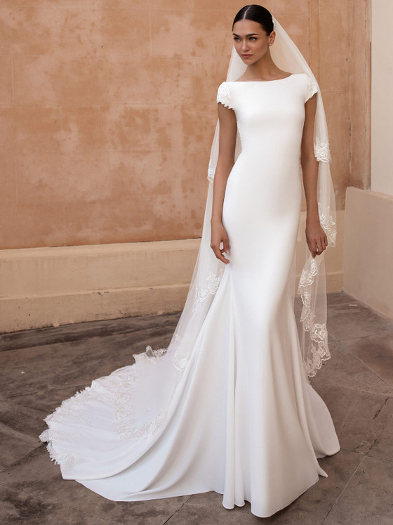 Sleek crepe sheath with bateau neckline, floral cap sleeves, and lace-trimmed cathedral train Sleek crepe sheath with bateau neckline, floral cap sleeves, and lace-trimmed cathedral train