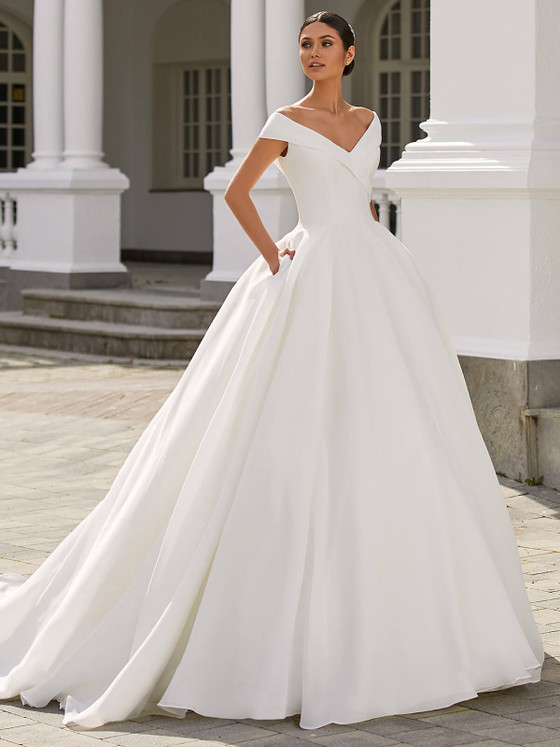 A modern fairytale moment, this off-shoulder satin ball gown stuns with timeless grace and hidden pockets A modern fairytale moment, this off-shoulder satin ball gown stuns with timeless grace and hidden pockets