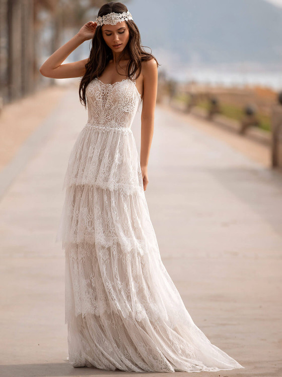 Boho dreams come true in this tiered lace gown, featuring a sheer bodice and effortless beachy romance Boho dreams come true in this tiered lace gown, featuring a sheer bodice and effortless beachy romance