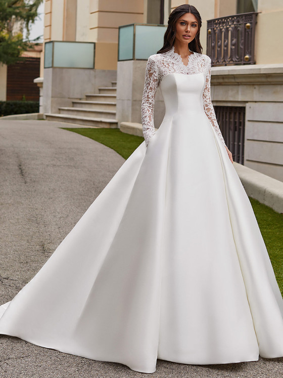 Elegant ball gown with long lace sleeves, illusion neckline, and structured mikado skirt with pockets Elegant ball gown with long lace sleeves, illusion neckline, and structured mikado skirt with pockets