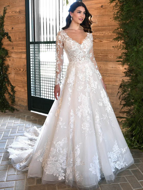 Romantic floral appliqués bloom over sheer sleeves and a dreamy tulle A-line silhouette Romantic floral appliqués bloom over sheer sleeves and a dreamy tulle A-line silhouette
