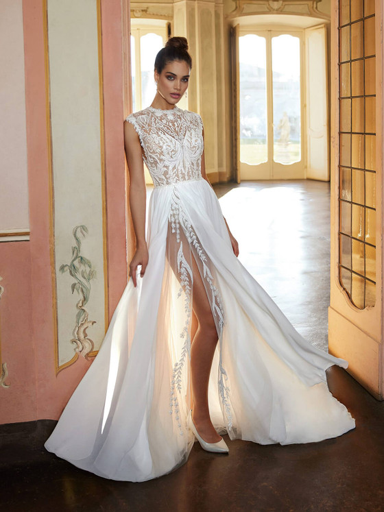 A-line gown with a high neckline lace bodice meets a sheer slit skirt for a bold yet elegant bridal statement A-line gown with a high neckline lace bodice meets a sheer slit skirt for a bold yet elegant bridal statement