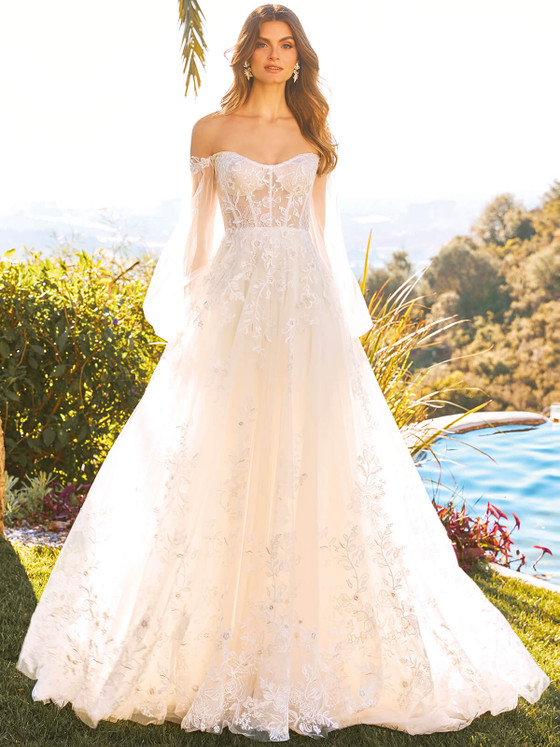 Romantic off-the-shoulder gown with sheer embroidered bodice and flowing floral lace skirt, perfect for an outdoor celebration Romantic off-the-shoulder gown with sheer embroidered bodice and flowing floral lace skirt, perfect for an outdoor celebration