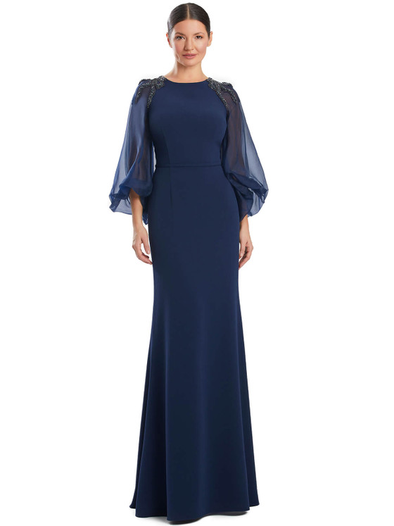 Sheer bishop sleeves with jeweled shoulders elevate this clean, structured gown Sheer bishop sleeves with jeweled shoulders elevate this clean, structured gown