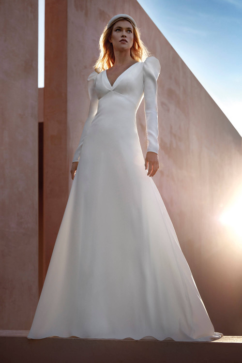 Elegant A-line gown with long sleeves, puffed shoulders, and a deep V-neckline for regal simplicity Elegant A-line gown with long sleeves, puffed shoulders, and a deep V-neckline for regal simplicity