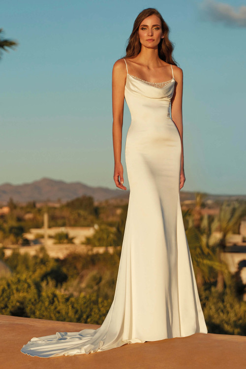 Chic satin gown features a draped cowl neckline with delicate beading and a sleek, fitted silhouette Chic satin gown features a draped cowl neckline with delicate beading and a sleek, fitted silhouette