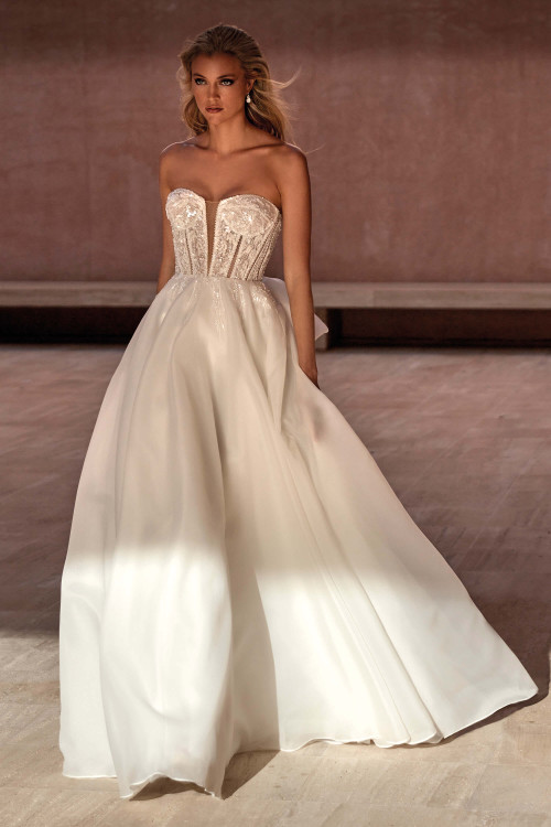 Modern ball gown with a strapless illusion corset bodice, sequin embellishments, and a full organza skirt Modern ball gown with a strapless illusion corset bodice, sequin embellishments, and a full organza skirt