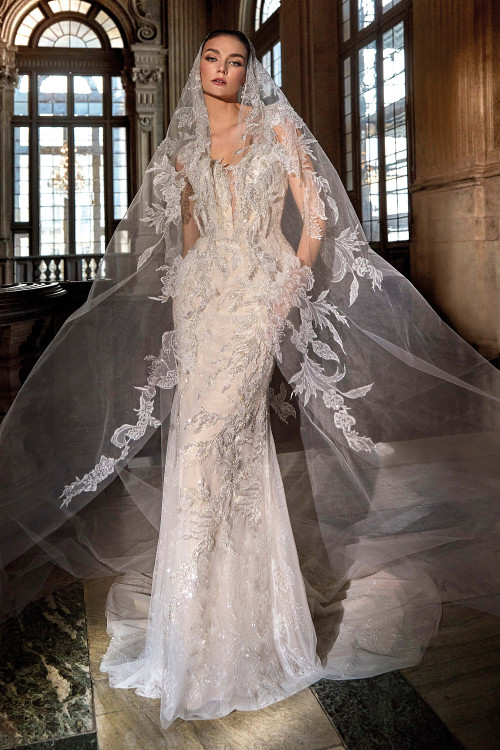 Regal fitted gown with shimmering embroidery, illusion neckline, and a dramatic cathedral veil adorned in matching lace Regal fitted gown with shimmering embroidery, illusion neckline, and a dramatic cathedral veil adorned in matching lace