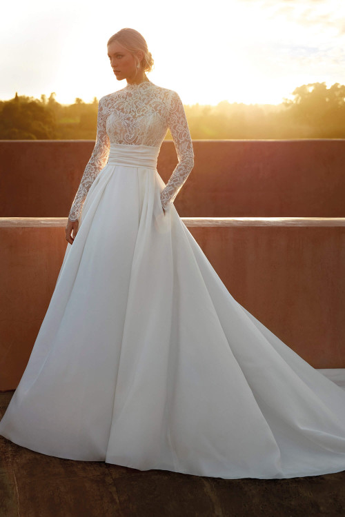 High-neck lace bodice with long sleeves, pleated mikado A-line skirt with pockets High-neck lace bodice with long sleeves, pleated mikado A-line skirt with pockets