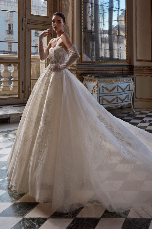 This regal ball gown dazzles with a strapless floral bodice, voluminous lace-embroidered skirt, and sheer detachable gloves This regal ball gown dazzles with a strapless floral bodice, voluminous lace-embroidered skirt, and sheer detachable gloves