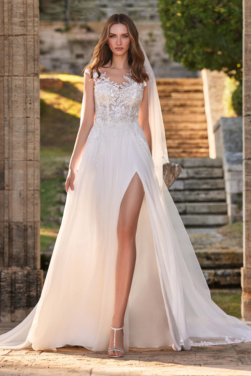 Illusion neckline with floral appliqués meets a flowing chiffon skirt and thigh-high slit Illusion neckline with floral appliqués meets a flowing chiffon skirt and thigh-high slit