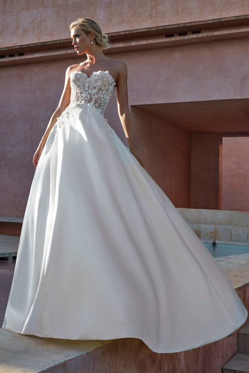 This romantic gown features a sheer floral lace bodice and sleek mikado A-line skirt for timeless allure This romantic gown features a sheer floral lace bodice and sleek mikado A-line skirt for timeless allure