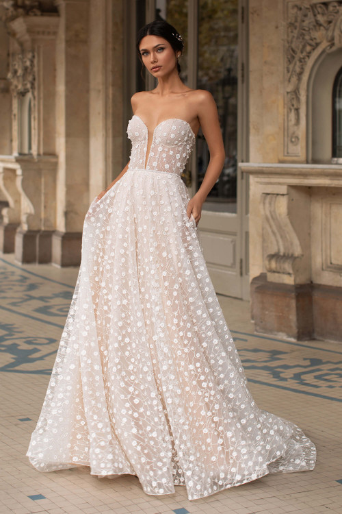 Whimsical strapless gown with a sheer corset bodice and dotted floral embroidery throughout Whimsical strapless gown with a sheer corset bodice and dotted floral embroidery throughout