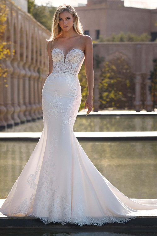 Chic fit-and-flare gown with a strapless illusion bodice and floral lace cascading down the skirt Chic fit-and-flare gown with a strapless illusion bodice and floral lace cascading down the skirt