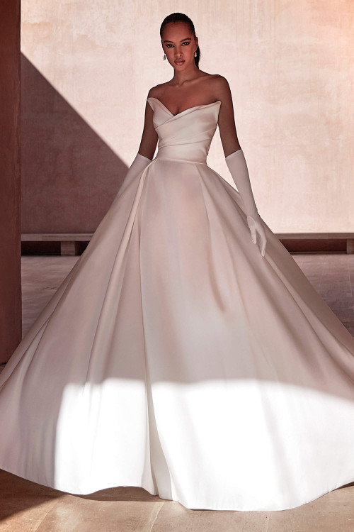 Elegant strapless ball gown with a pleated bodice and full mikado skirt for timeless drama Elegant strapless ball gown with a pleated bodice and full mikado skirt for timeless drama