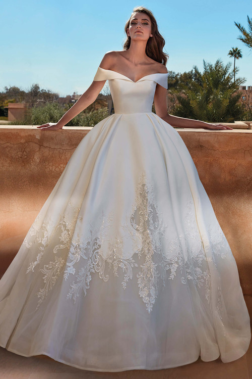 Off-the-shoulder ball gown with a structured satin bodice and ornate embroidery along the full skirt Off-the-shoulder ball gown with a structured satin bodice and ornate embroidery along the full skirt