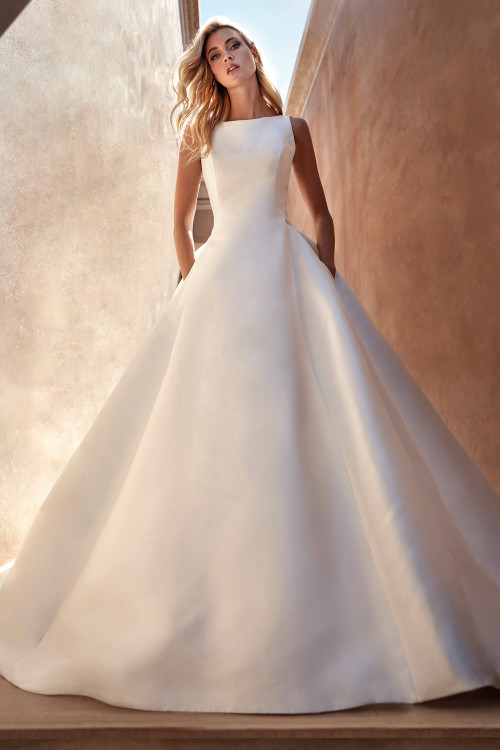 Timeless mikado ballgown with high neckline, structured bodice, voluminous skirt and hidden pockets. Timeless mikado ballgown with high neckline, structured bodice, voluminous skirt and hidden pockets.