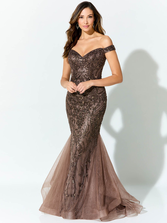 Mocha tulle gown stuns with shimmering beadwork and a flattering off-shoulder neckline Mocha tulle gown stuns with shimmering beadwork and a flattering off-shoulder neckline