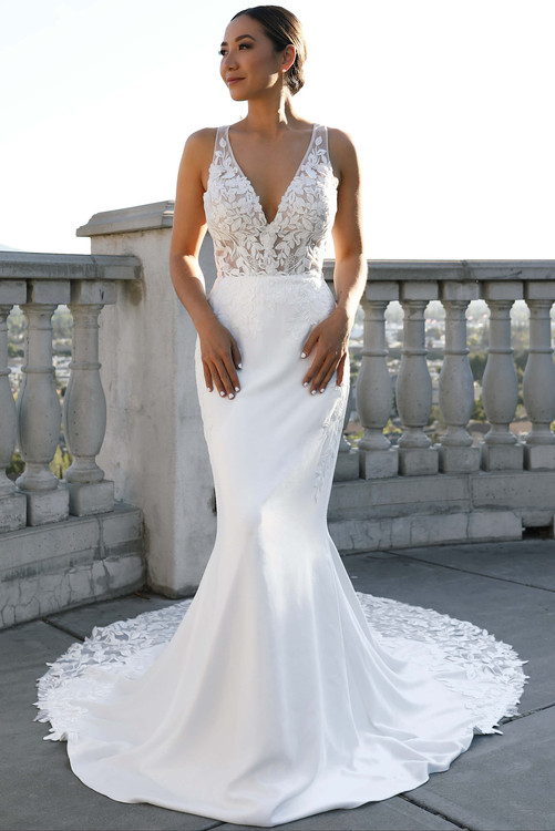 Gracefully modern, this fitted gown stuns with a sheer floral bodice and petal-dusted chapel train Gracefully modern, this fitted gown stuns with a sheer floral bodice and petal-dusted chapel train