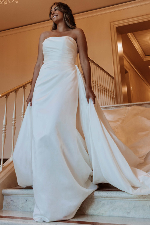 Strapless satin gown with draped bodice and sweeping detachable overskirt Strapless satin gown with draped bodice and sweeping detachable overskirt