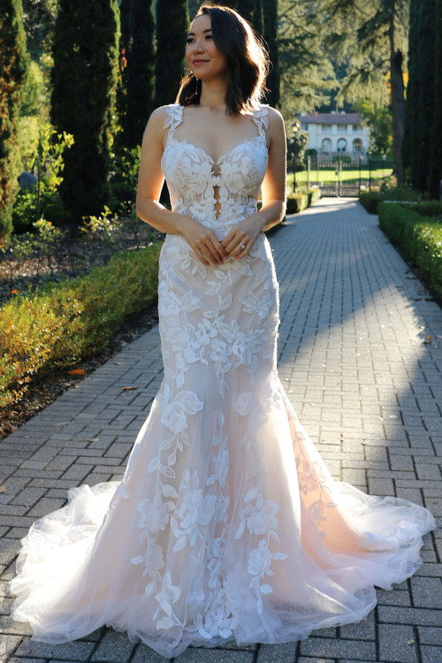 Romantic floral appliqués bloom over sheer tulle in this sculpted fit-and-flare silhouette Romantic floral appliqués bloom over sheer tulle in this sculpted fit-and-flare silhouette