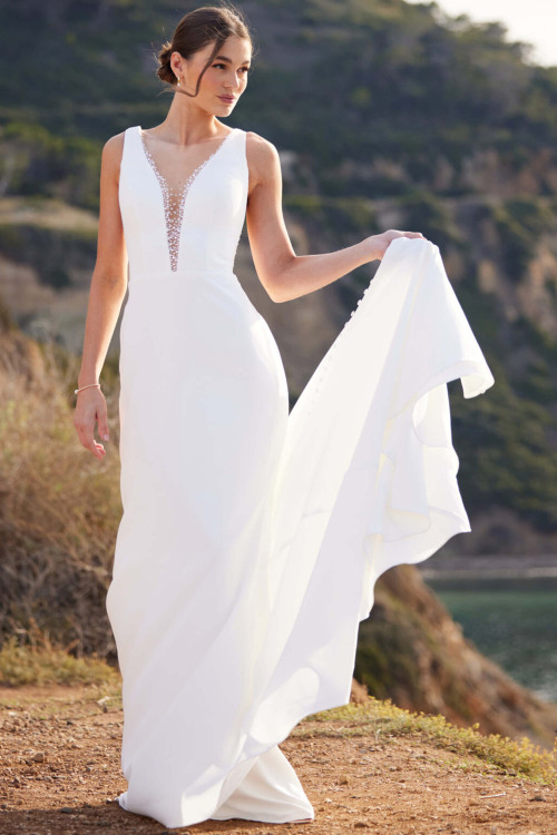 Sleek crepe gown with plunging beaded neckline and flowing train Sleek crepe gown with plunging beaded neckline and flowing train