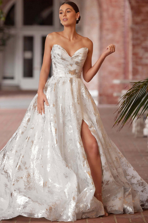Drenched in metallic shimmer, this strapless ballgown stuns with a daring leg slit Drenched in metallic shimmer, this strapless ballgown stuns with a daring leg slit