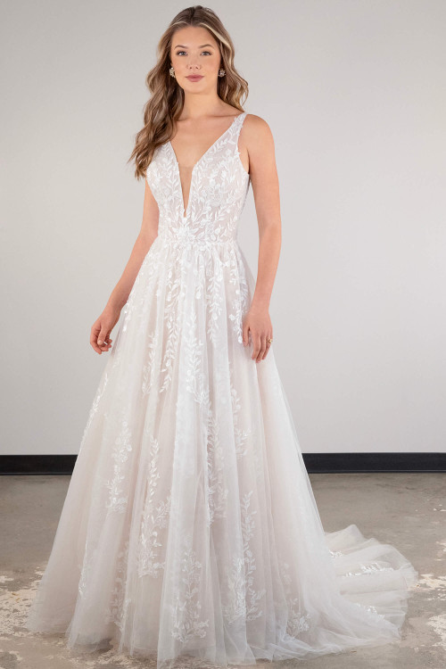 Delicate floral lace cascades over this plunging tulle gown for a romantic, ethereal look Delicate floral lace cascades over this plunging tulle gown for a romantic, ethereal look