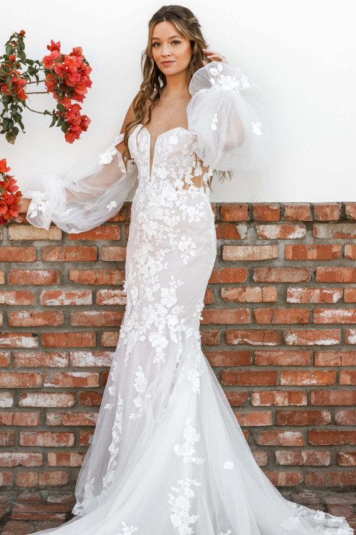 This floral lace fit-and-flare gown enchants with sheer sleeves and sculpted elegance This floral lace fit-and-flare gown enchants with sheer sleeves and sculpted elegance
