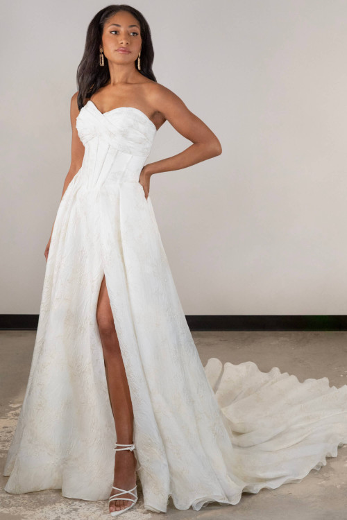 Textured jacquard gown stuns with a pleated bodice and daring front slit Textured jacquard gown stuns with a pleated bodice and daring front slit