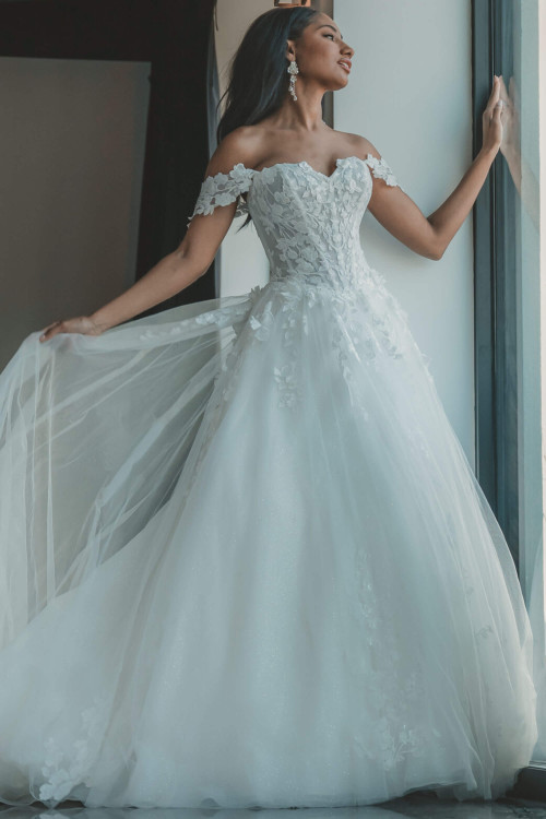 Floral appliqués bloom across a dreamy off-shoulder tulle A-line gown Floral appliqués bloom across a dreamy off-shoulder tulle A-line gown