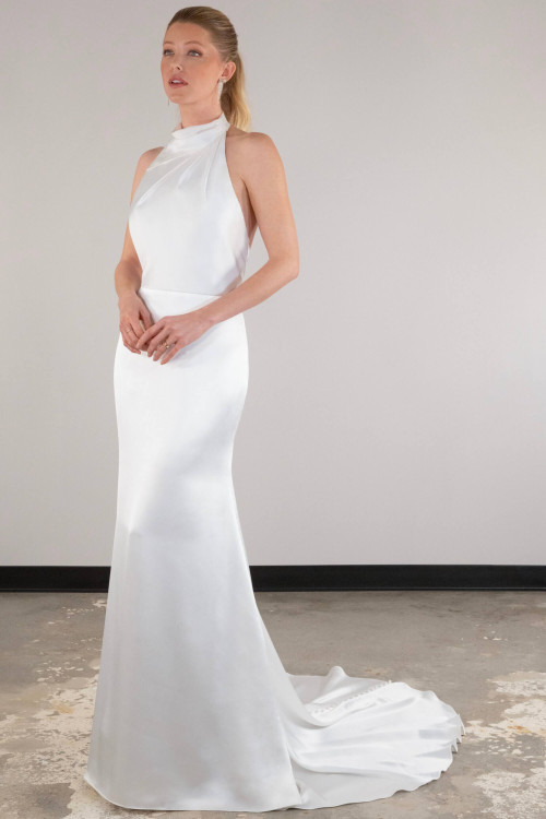 Sleek satin gown stuns with a high halter neckline and figure-hugging silhouette Sleek satin gown stuns with a high halter neckline and figure-hugging silhouette