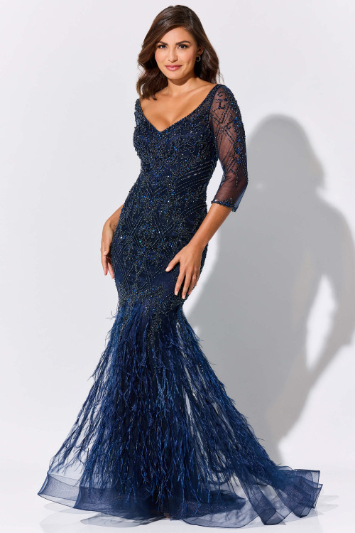 Navy beaded gown shimmers with feathered godets and sheer sleeves for a dramatic finish Navy beaded gown shimmers with feathered godets and sheer sleeves for a dramatic finish