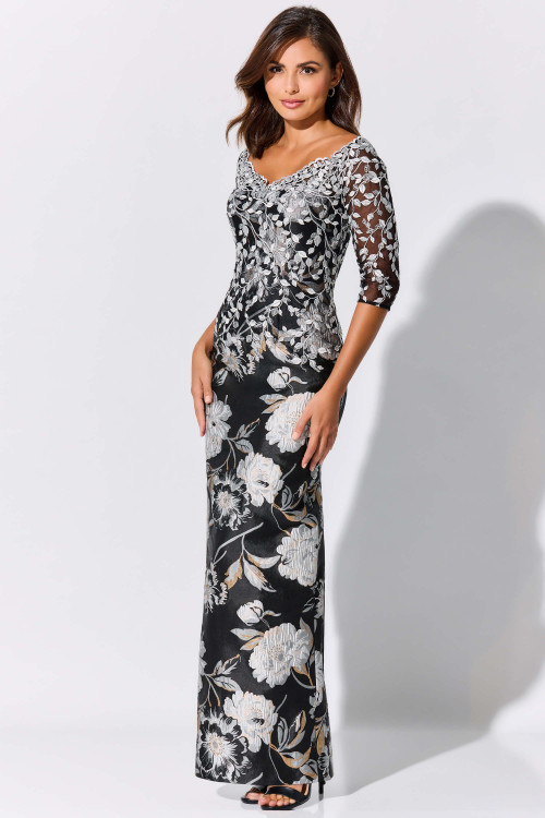 Ivory embroidery climbs over sheer sleeves and a sleek black column silhouette Ivory embroidery climbs over sheer sleeves and a sleek black column silhouette