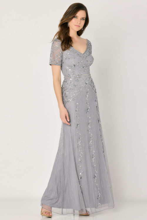 Gown with beaded vines, scalloped waist, detachable cap sleeves, and a soft V-neckline Gown with beaded vines, scalloped waist, detachable cap sleeves, and a soft V-neckline