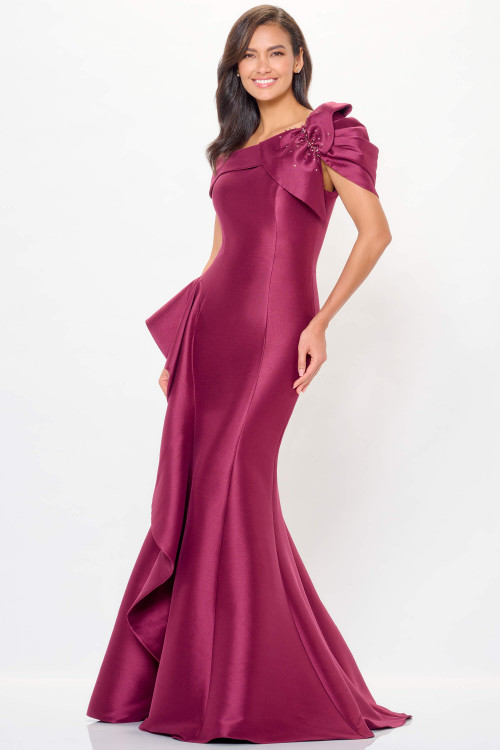 Asymmetrical off-the-shoulder berry gown with sculpted fit and ruffle accent on the skirt Asymmetrical off-the-shoulder berry gown with sculpted fit and ruffle accent on the skirt