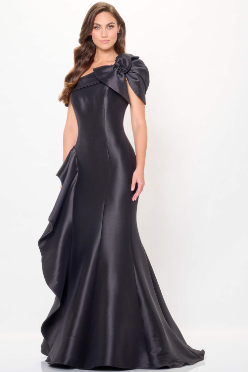 Bold black mermaid silhouette with oversized ruffle shoulder and asymmetric neckline