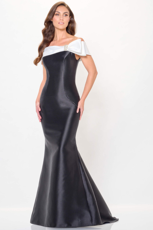 Off-shoulder black fitted gown with oversized white satin bow and jeweled accent Off-shoulder black fitted gown with oversized white satin bow and jeweled accent