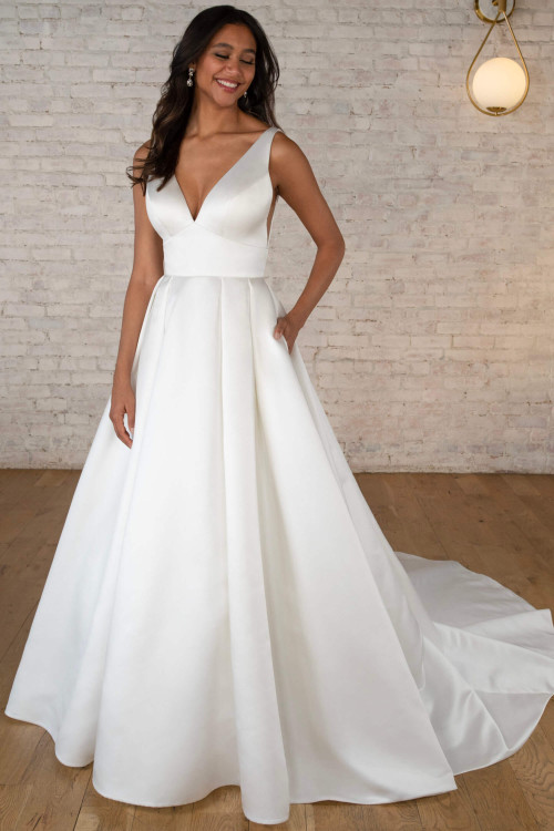 Clean satin ball gown with plunging V-neckline and box pleat skirt Clean satin ball gown with plunging V-neckline and box pleat skirt