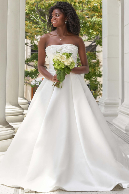 Strapless satin ball gown with pearl-embellished bodice and clean pleats Strapless satin ball gown with pearl-embellished bodice and clean pleats