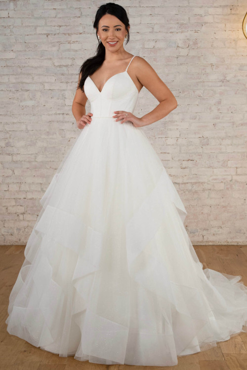 Tiered tulle ball gown with plunging V-neck and sparkling shimmer layers Tiered tulle ball gown with plunging V-neck and sparkling shimmer layers