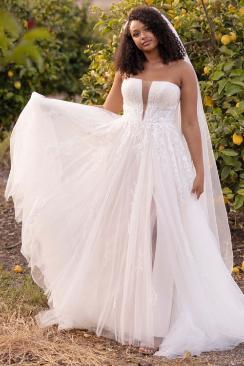 Ethereal tulle gown with floral appliqués, illusion plunge, and flirty slit Ethereal tulle gown with floral appliqués, illusion plunge, and flirty slit