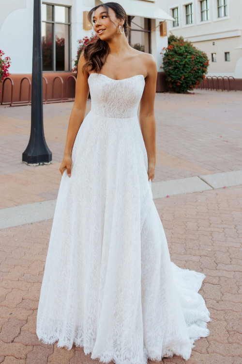 Strapless lace A-line gown with soft scoop neckline and elegant drape Strapless lace A-line gown with soft scoop neckline and elegant drape