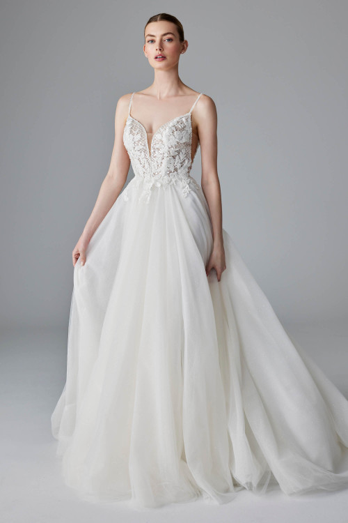Sheer floral lace bodice with delicate straps flows into a sparkling tulle A-line skirt Sheer floral lace bodice with delicate straps flows into a sparkling tulle A-line skirt