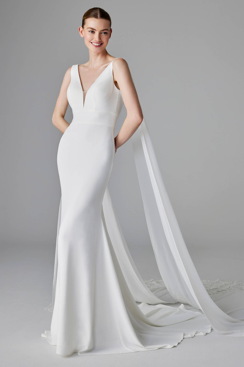 Modern crepe gown with a plunging V-neckline and flowing shoulder streamers for soft drama Modern crepe gown with a plunging V-neckline and flowing shoulder streamers for soft drama
