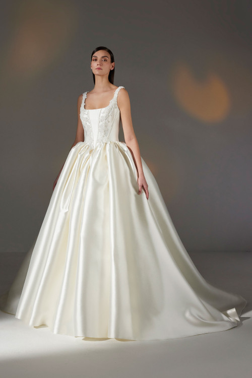 Regal Mikado ball gown featuring a corset-style floral appliqué bodice, square neckline, and voluminous pleated skirt Regal Mikado ball gown featuring a corset-style floral appliqué bodice, square neckline, and voluminous pleated skirt