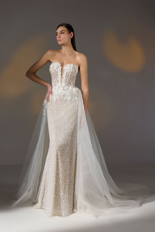 Plunging strapless gown with 3D floral appliqués and sheer tulle overskirt for added drama Plunging strapless gown with 3D floral appliqués and sheer tulle overskirt for added drama