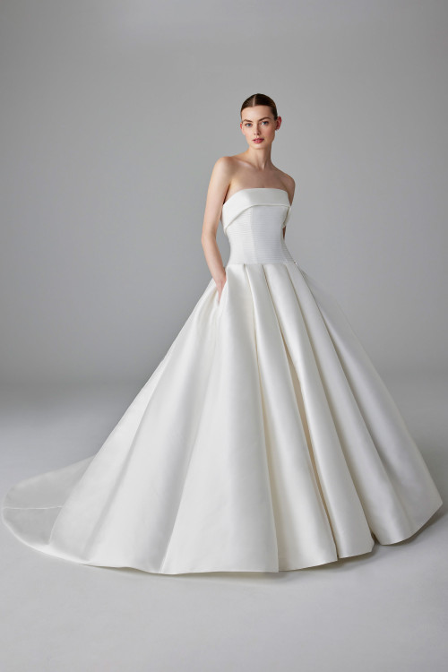 Strapless ballgown with a structured pleated bodice and voluminous skirt with pockets Strapless ballgown with a structured pleated bodice and voluminous skirt with pockets