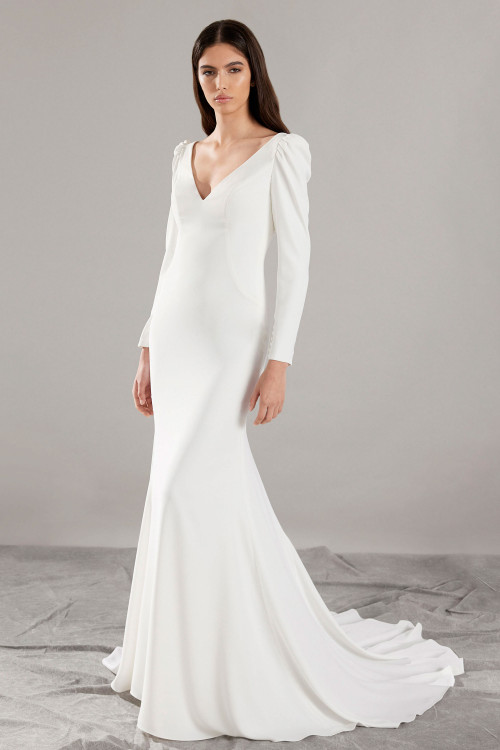 Elegant crepe gown with long puff sleeves and a deep V-neckline for timeless sophistication Elegant crepe gown with long puff sleeves and a deep V-neckline for timeless sophistication